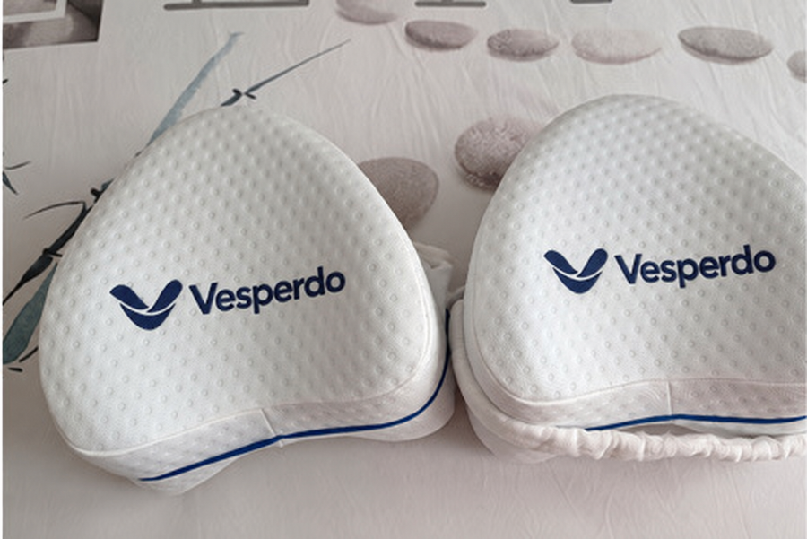 Two Vesperdo knee pillows with navy branding.